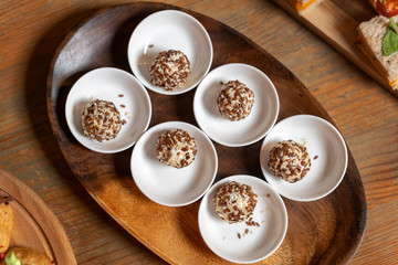Cream cheese balls coated with white and brown sesame seeds. Tasty treat.