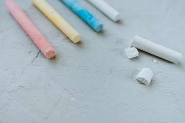 Multi-colored crayons on a gray background.