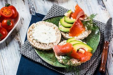 salted salmon fillet with crispbread and avocado. Aromatic herbs, spices and vegetables - healthy food, diet concept. cherry tomato. superfood, open sandwich, smorrebrod. breakfast concept
