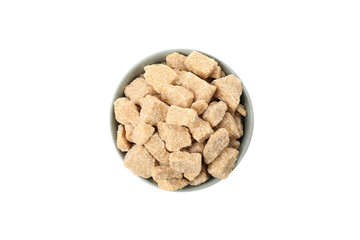 Bowl with brown sugar slices isolated on white background