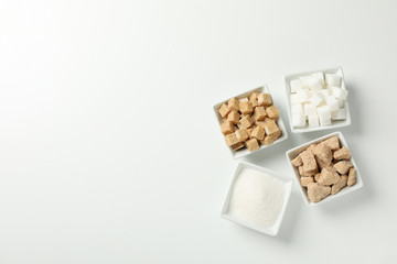 Square bowls with sugar on white background, top view