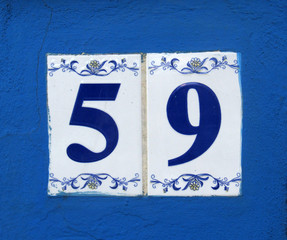 Vintage grunge square metal rusty plate of number of street address with number. Close up, brand.