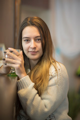 Close-up portrait of a young girl in a cafe.