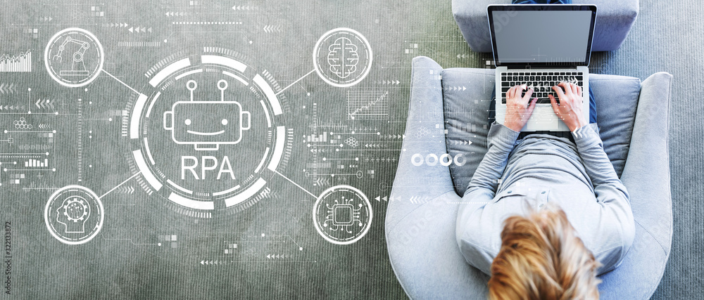 Poster robotic process automation concept with man using a laptop in a modern gray chair