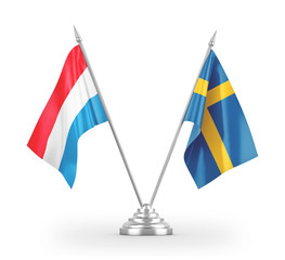 Sweden and Luxembourg table flags isolated on white 3D rendering