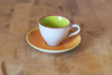 Porcelain cup with plate on the wooden table