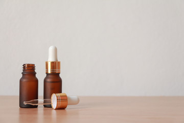 facial essential oil or serum packaging on wood table against White Background. Beauty cosmetic product for skincare concept.copt space.