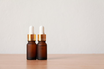 facial essential oil or serum packaging on wood table against White Background. Beauty cosmetic product for skincare concept.copt space.