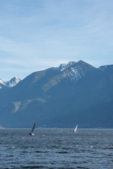 Sailing boats with really big mountains in the back. The picture was taken in Vancouver
