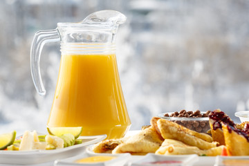 Winter Breakfast orange juice and pancakes on the terrace in front of the restaurant against the...