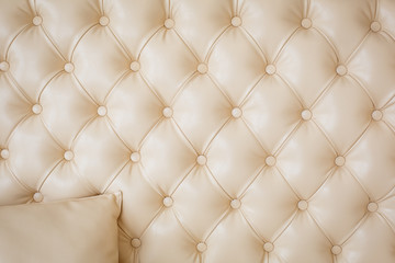 Texture beige leather sofa upholstery. Background-soft leather wall with diamonds