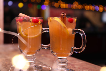 Tasty aromatic mulled wine on wooden table