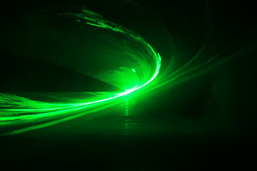 Green laser in black background