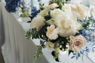 bouquet of blue flowers and white flowers at wedding table