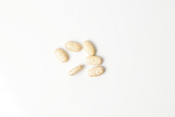 Multivitamin pills on a white background. Top view.