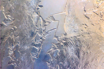 blurred background of ice patterns and frozen water on glass. natural textures and backgrounds. ice patterns on frozen