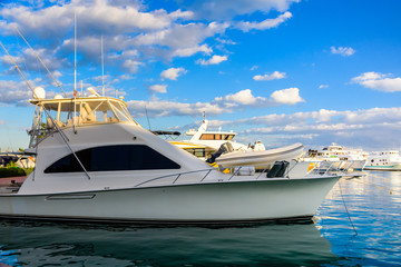 Naklejka premium White luxury yacht in a sea harbor of Hurghada, Egypt. Marina with tourist boats on Red Sea