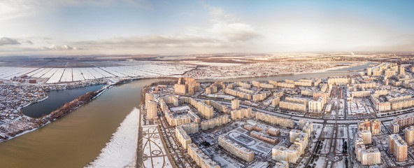 winter air drone landscape - Brzhegokai black lake near Kuban river, snow-covered high-rise apartment buildings on Rozhdestvenskaya embankment on the western outskirts of Krasnodar (southern Russia)