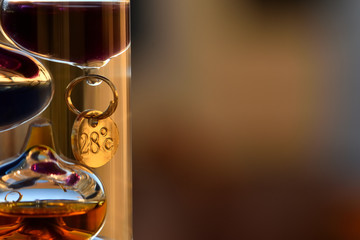 Galileo thermometer with bright colors and reflections in different backgrounds