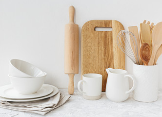 Kitchen white tableware wooden utensils on the table.