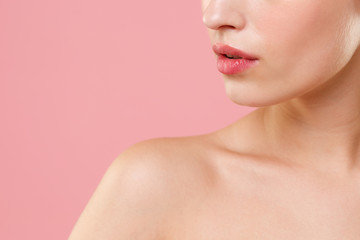 Obraz na płótnie Canvas Close up cropped blonde half naked woman 20s perfect skin lips nude make up isolated on pastel pink wall background studio portrait. Skin care healthcare cosmetic procedures concept Mock up copy space