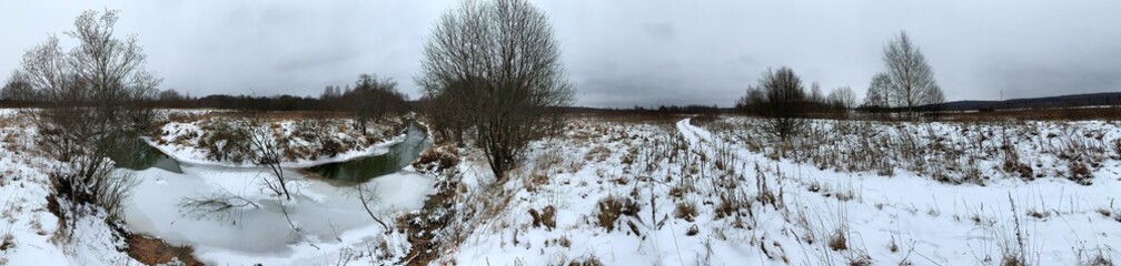 Panoramic view with winter river and snow forest. Beautiful winter landscape