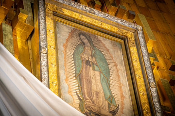 Our Lady of Guadalupe with mexican flag in Mexico City - obrazy, fototapety, plakaty
