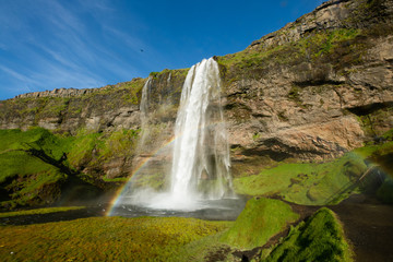 Scenic Seljalandsfoss waterfall with rainbow