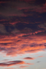 beautiful dramatic sky with dark and bright clouds at sunset, summer landscape, golden sunlight