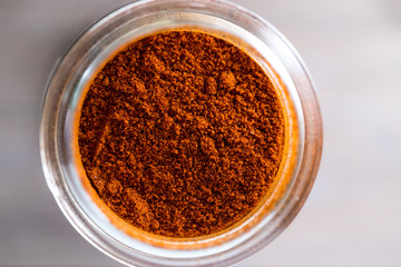 Red Cayenne pepper, hot ground pepper macro top view