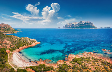 Fototapeta premium View from flying drone. Incredible spring view of Spiaggia del dottore beach. Superb morning scene of Sardinia island, Italy, Europe. Sunny Mediterranean seascape with Tavolara island on background..
