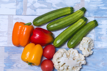 Ripe vegetables close-up, peppers, tomatoes, zucchini and cauliflower side view