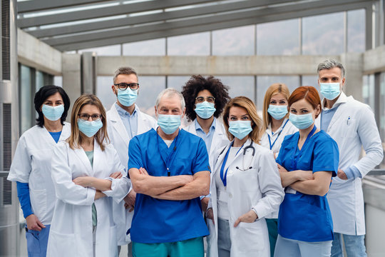 Group of doctors with face masks looking at camera, corona virus concept.