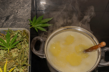 Making of marijuana butter with leafs and yellow butter which will be green
