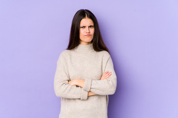 Young caucasian woman isolated on purple background unhappy looking in camera with sarcastic expression.