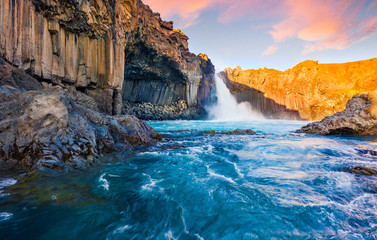 View from flying drone. Great summer sunrise on Ingvararfoss waterfall. Attractive morning scene of...