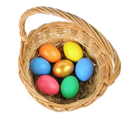 Colorful Easter eggs in the basket on the white background