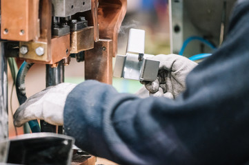 Spot welding machine Industrial automotive part in factory. Operator working in industry .