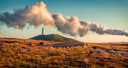 Panoramic summer view of Reykjanes Lighthouse with steam from a Gunnuhver Hot Springs. Exotic...