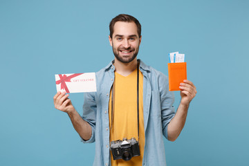 Smiling traveler tourist man in casual clothes with photo camera isolated on blue background....