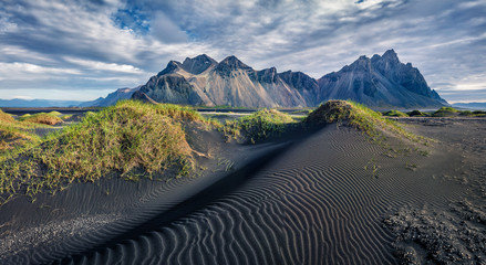 Awesome midnight sun view of Stokksnes cape with Vestrahorn (Batman Mountain) on background. Summer...