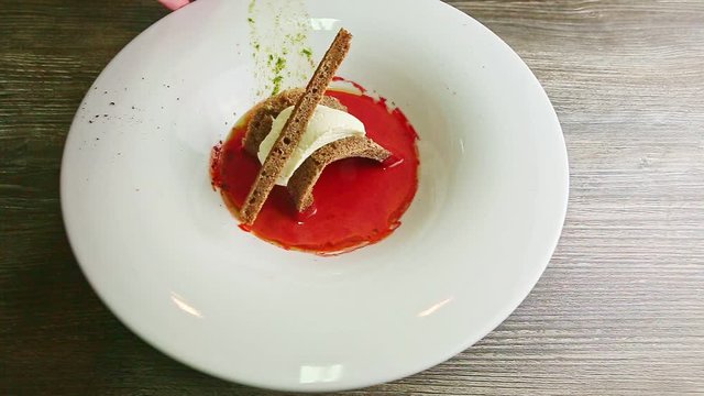 human hand rotates deep bowl with ukrainian borscht and sour cream
