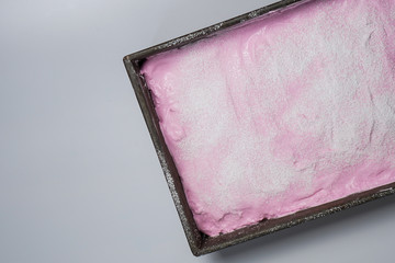 Pink marshmallows in a metal pan