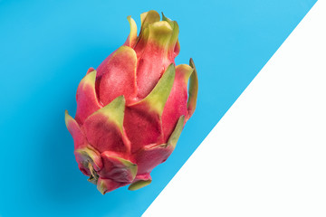 Fototapeta premium dragon fruit, pitaya, lies on a turquoise background, divided into white. Proper nutrition. Diet.