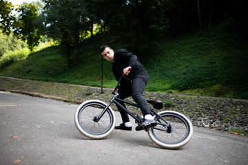Fototapeta premium The guy on the BMX slows down sharply. In the park.