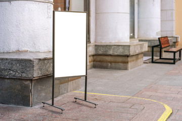 advertisement blank sign board in black frame standing on pavement beside store