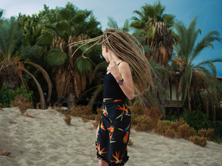 Young woman with dreadlocks over summer background
