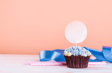 Chocolate cupcakes with small flowers of curd cream. Place for the inscription.