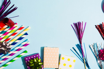 Colorful accessories for holiday party on blue background with copy space