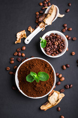 Mushroom Chaga Coffee Superfood Trend-dry and fresh mushrooms and coffee beans on dark background with mint. Coffee break